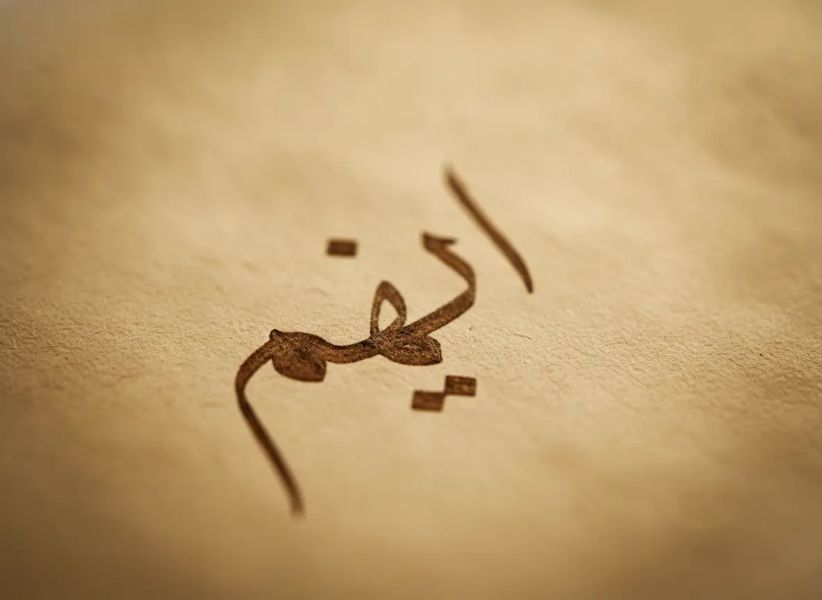 Close-up of brown Arabic calligraphy on parchment-like paper, an abstract decorative text.
